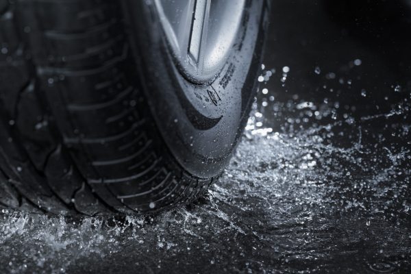 Car tire splashing in water.